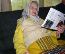 Erikos Straigytės nuotraukoje: be akinių vis dar laikraščius skaitanti 97 m. senolė Julija iš Varėnos